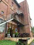 A view of a courtyard with a fountain and a metal staircase.