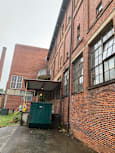 A view of a building's roof with a green container on the right side.