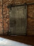 A brick wall with a metal beam.