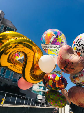 a bunch of balloons in the shape of a number nine and a heart