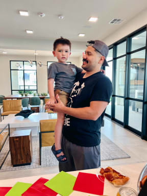 a man holding a child in a living room