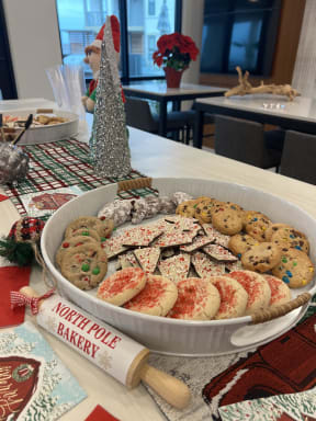 a tray of cookies and crackers on a table with a christmas tree