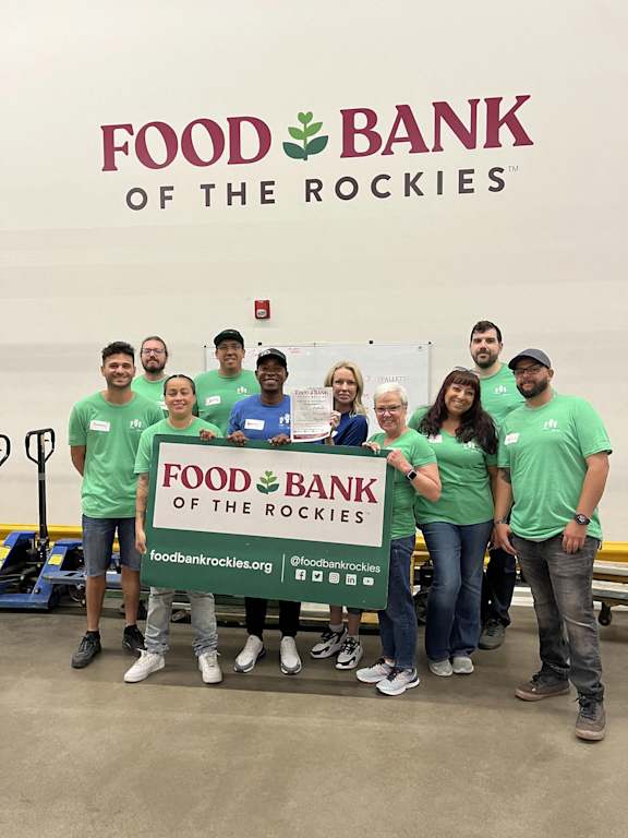 Food Bank of the Rockies logo with people standing in front of it.