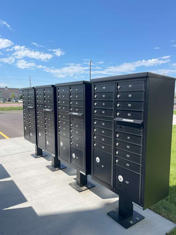 A row of black mailboxes with numbers on them.