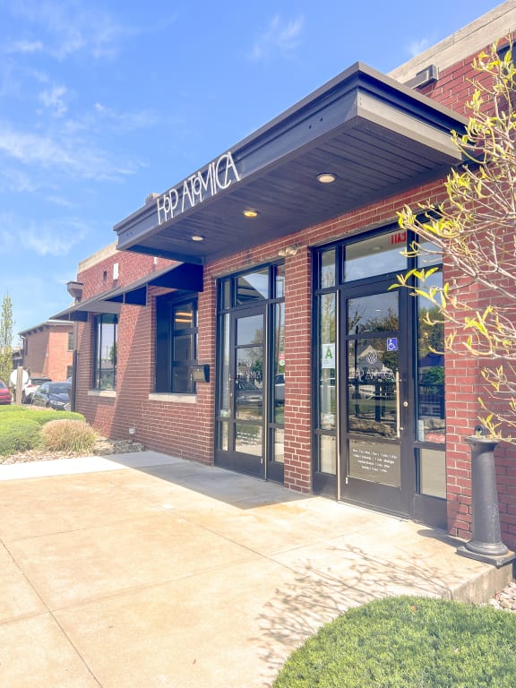 the front of a restaurant with glass doors and a sidewalk