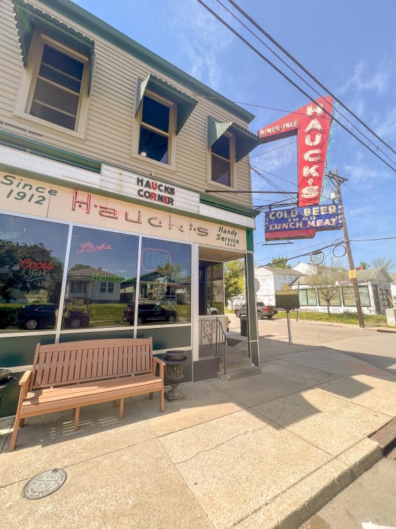 a bench in front of a restaurant on a street