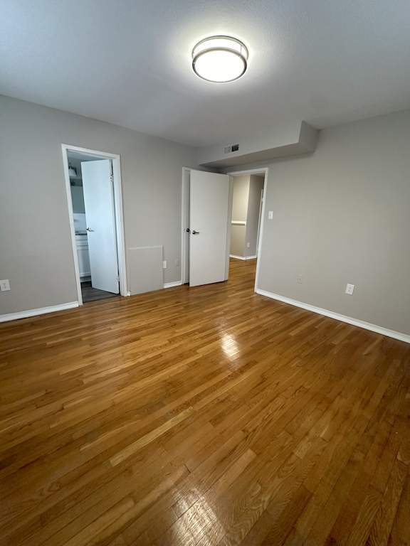 A room with wooden floors and white walls.