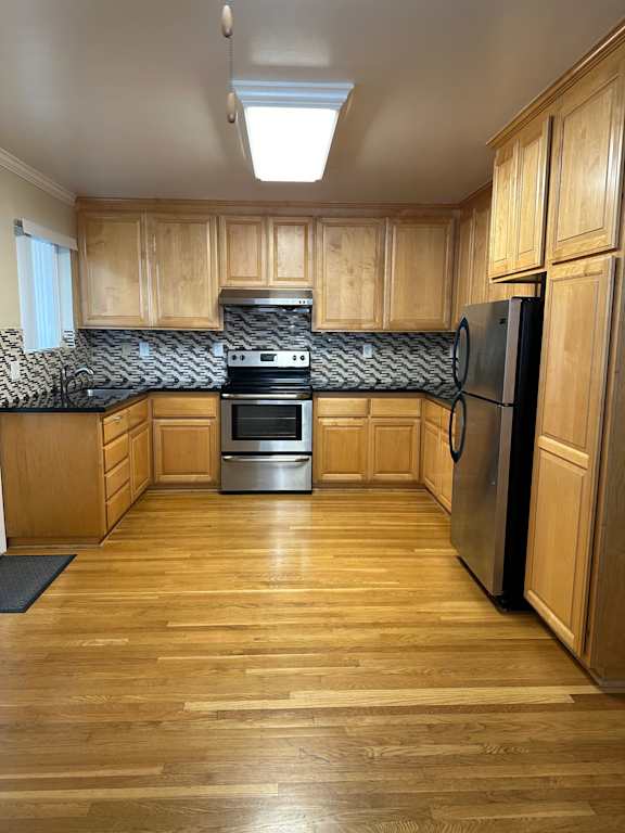 a kitchen with a sink and a stove and a refrigerator