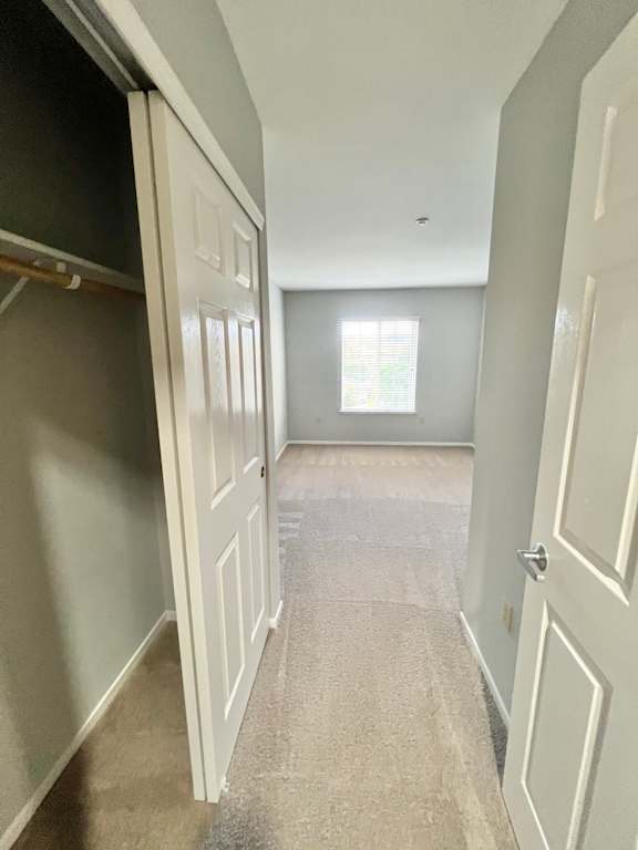 an empty room with a closet and an open door