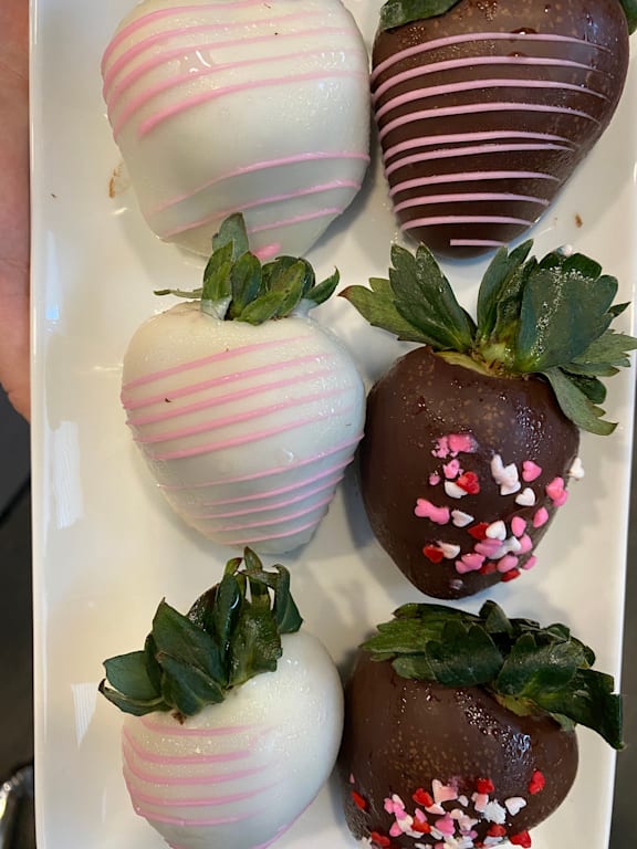 a white plate with four chocolate covered strawberries on it at LIV at Boerne Hills an Active Senior Community 62+, Boerne, TX, 78006