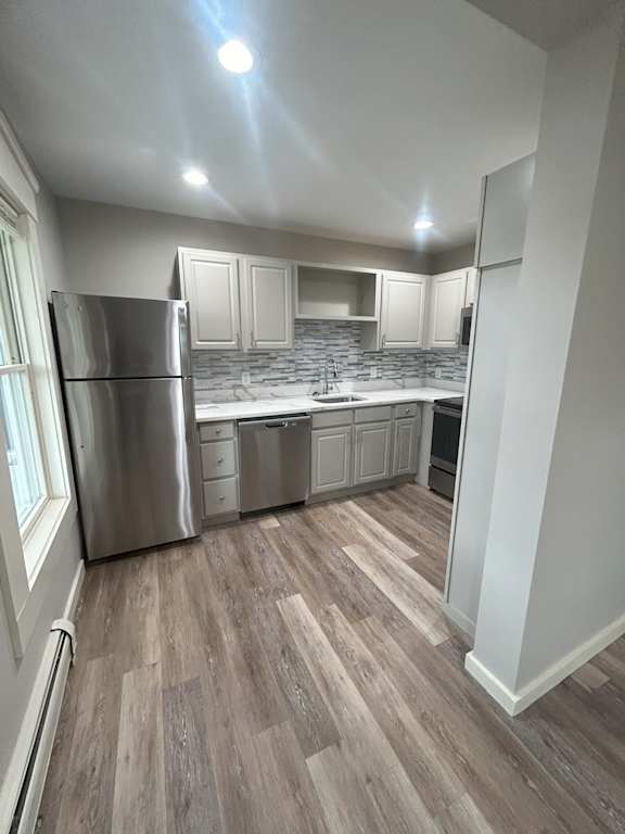 a kitchen with white cabinets and stainless steel appliances at Briarcliff at Quechee, Quechee