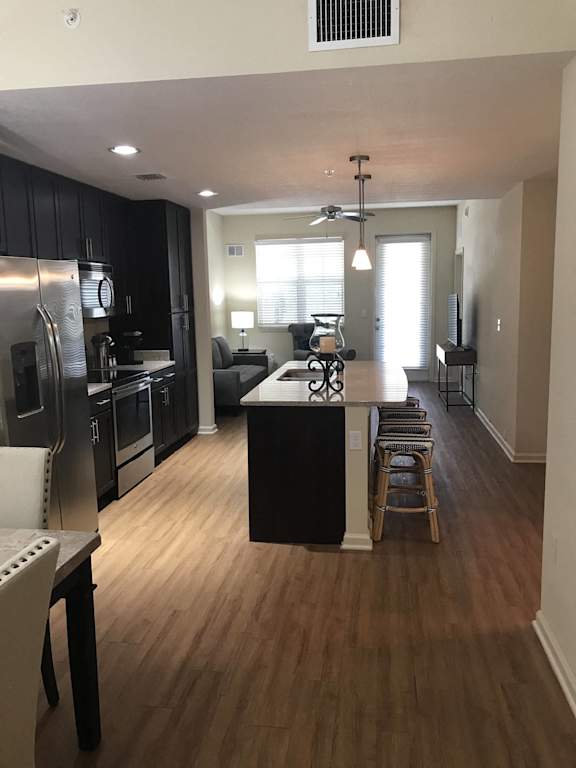 an aerial view at The Dakota Apartments, Florida 33458 of a kitchen and living room