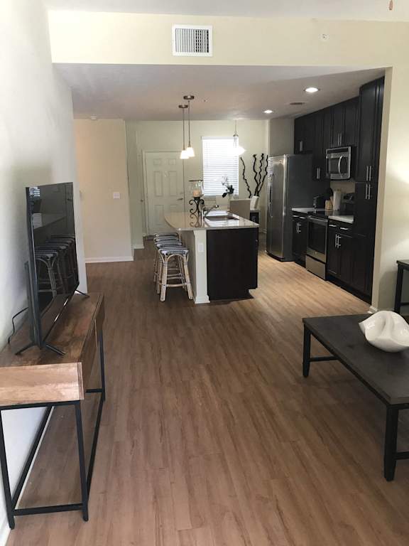 a view of the at The Dakota Apartments, Florida 33458 living room and kitchen from the dining room