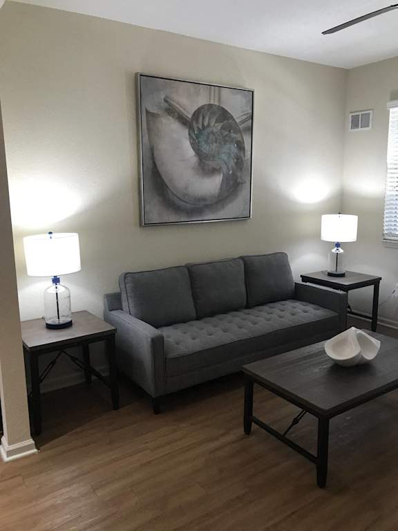 a living room  at The Dakota Apartments, Florida 33458with a couch and tables