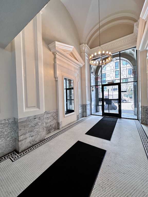 a large hallway with a chandelier and large windows