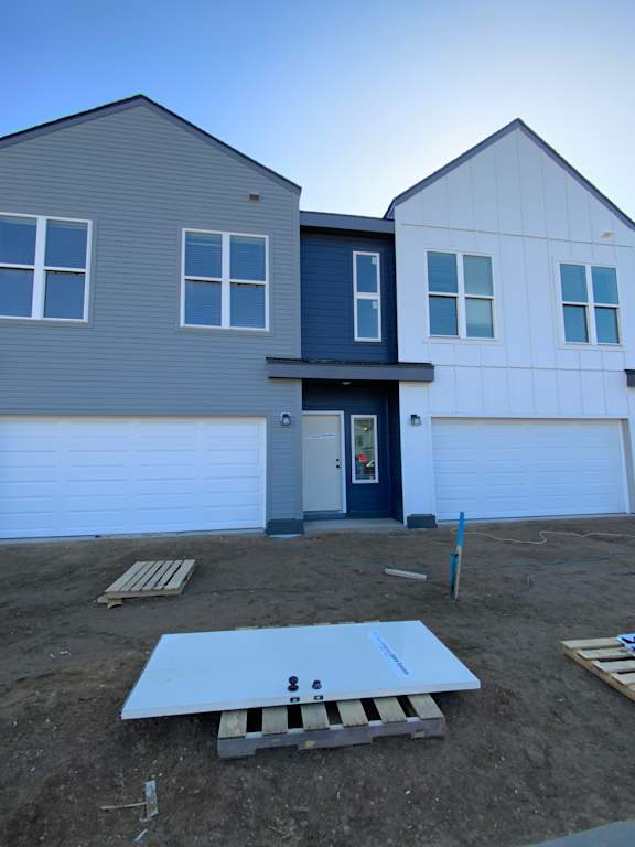 A modern house with a flat roof and a garage door.