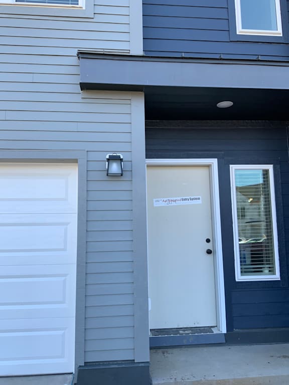 A white garage door with a white sign on it.