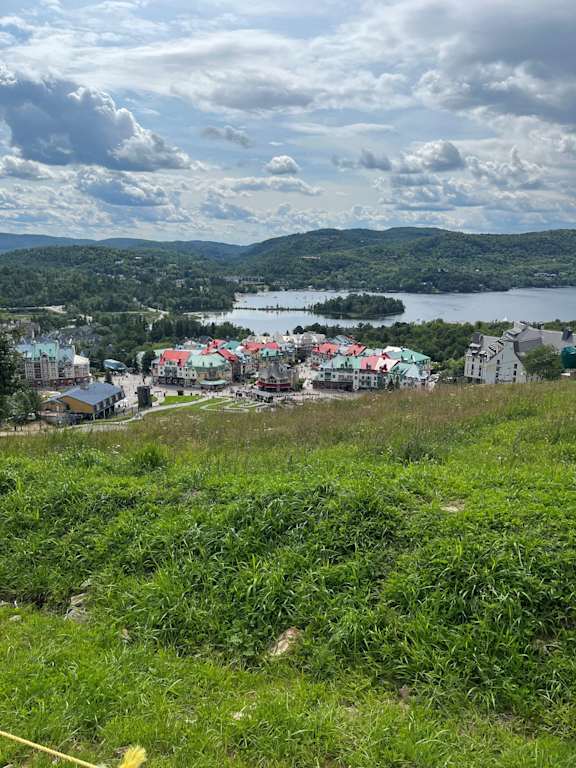 a city on a hill overlooking a lake and a town