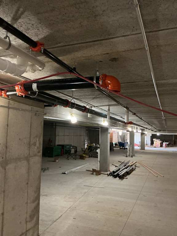 A construction site with a red and white pipe system.