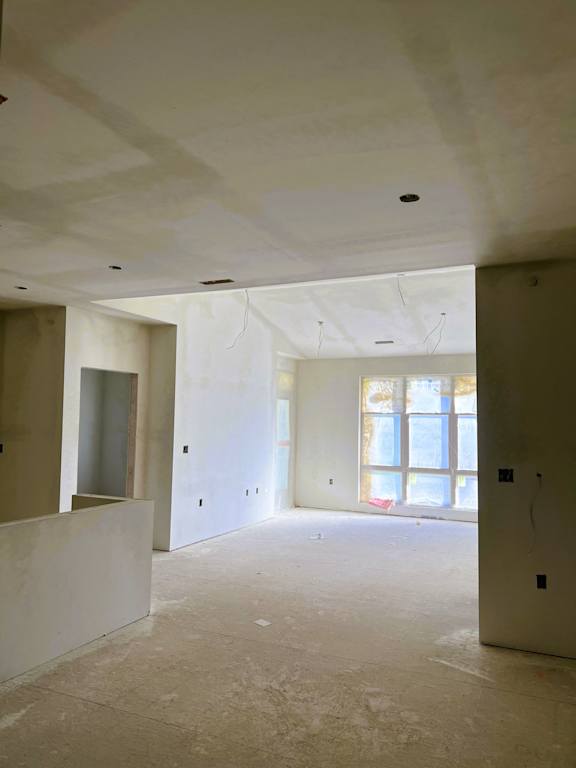 A room under construction with unfinished walls and ceiling.