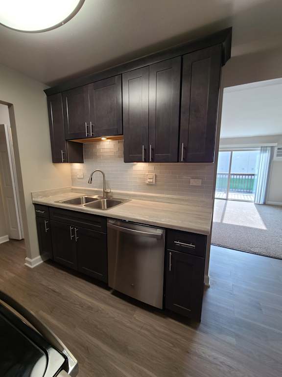 Rehabbed kitchen with slate grey cabinets and glass backsplash