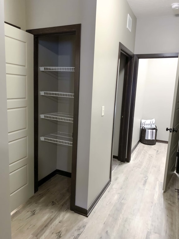 Hallway linen closet and laundry room in the Harper three bedroom floor plan