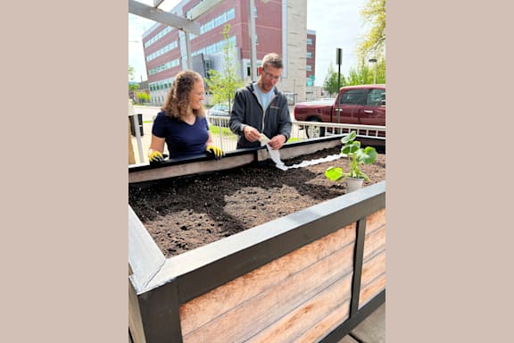 a man and a woman tending to a garden