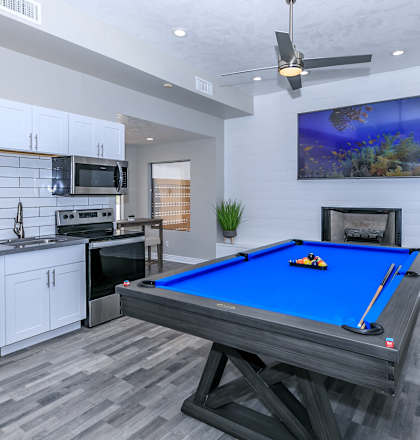 a games room with a pool table and a kitchen at Tides at Mesa, Mesa, AZ, 85204