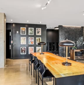 a dining room with a wooden table and black chairs
