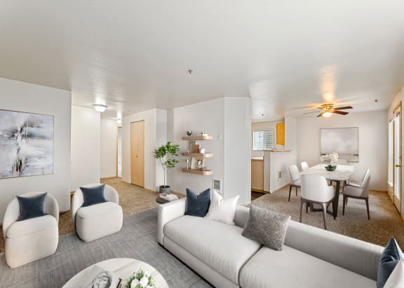 a living room with couches and chairs and a dining table