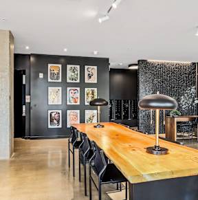 a dining room with a wooden table and black chairs