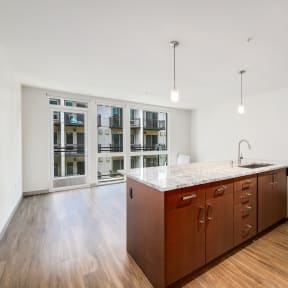 a large kitchen with wood floors and a large island in the middle