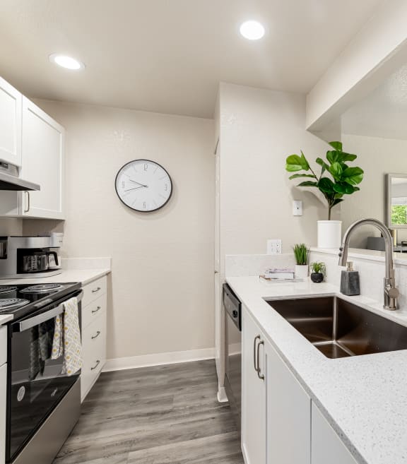 a kitchen with a counter and three stools