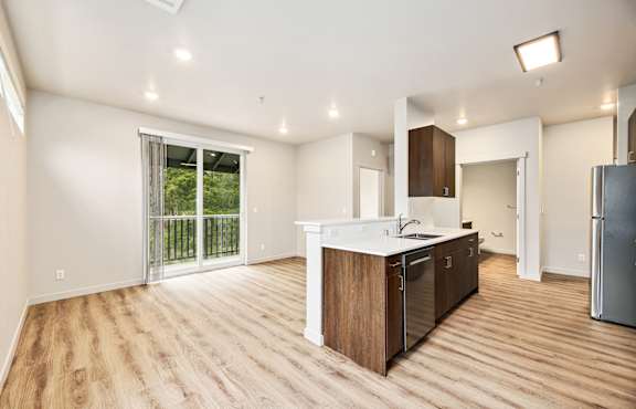 A kitchen with wooden floors and white walls.
