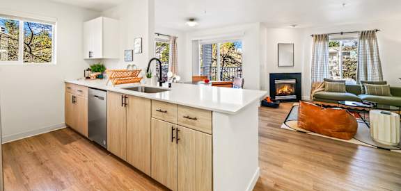 A modern kitchen with wooden cabinets and a white countertop.