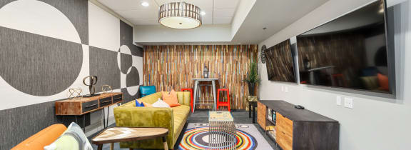 a living room with couches and chairs and a wall with an