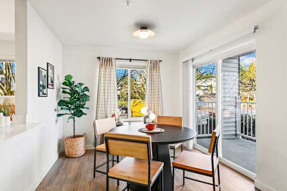A dining room with a table and chairs.