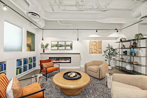 A modern living room with a fireplace and comfortable seating.