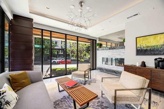 a living room with a couch and a coffee table and a fireplace