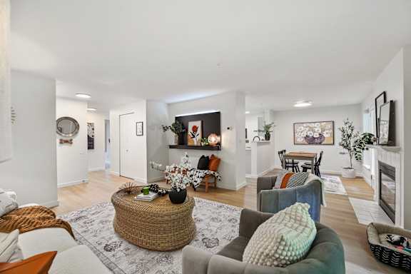 a living room with couches and chairs and a fireplace