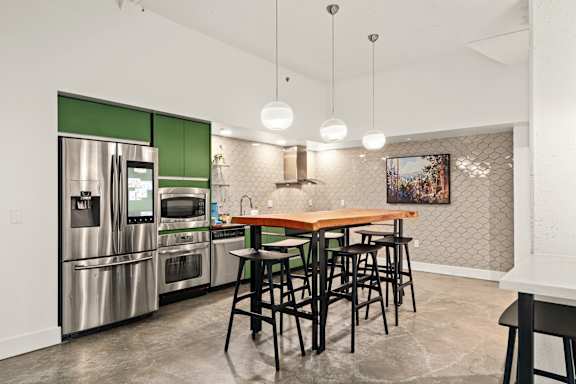 A kitchen with a table and chairs.