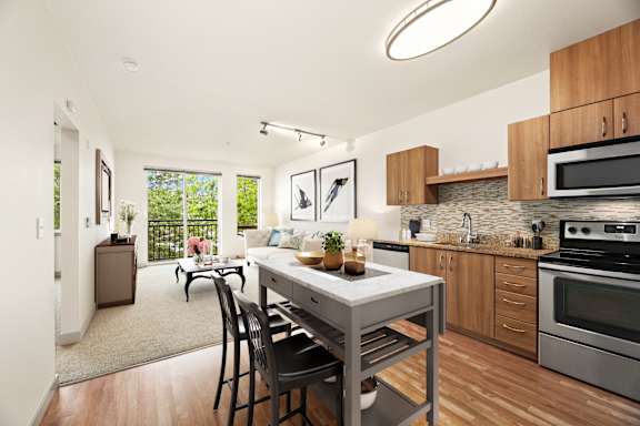 an open kitchen and living room with a table and chairs
