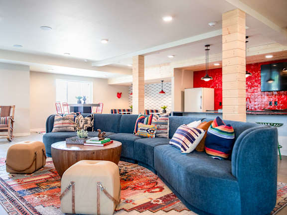 a living room with a blue couch and a rug