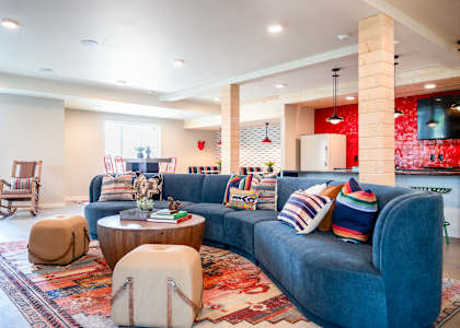 a living room with a blue couch and a rug at Scouter's Mountain, Happy Valley Oregon