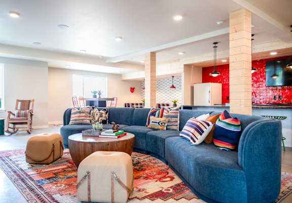 a living room with a blue couch and a rug