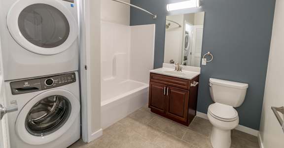 a bathroom with a washer and dryer in it