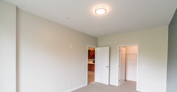 a bedroom with grey carpet and white walls