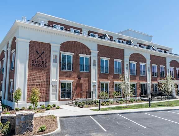a brick building with white pillars and a sign that says store front