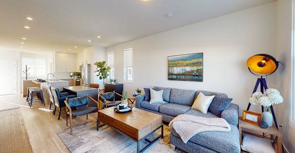 A living room with a grey couch and a wooden coffee table.