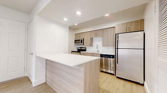 Apartment kitchen with stainless steel appliances at Avia Lofts at Maple Road, New York